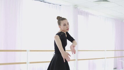 Young ballerina makes beautiful movements with her hands. © stanis88