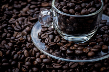coffee beans in a cup and around the cup