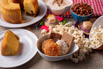 June party. Typical sweets from festa junina. Cornmeal cake, popcorn, hominy, paçoca, cocada, pumpkin jam, and peanuts