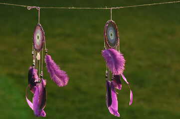 Purple dream catcher with feathers on street