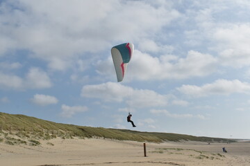 Paragliding at the beach of Katwijk aan Zee. Paraglider's making use of updraft of the dunes to stay in the air