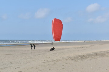 Paragliding at the beach of Katwijk aan Zee. Paraglider's making use of updraft of the dunes to stay in the air