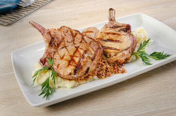Grilled pork chops with spices
Savory grilled meat with smashed potatoes