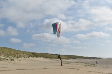 Paragliding at the beach of Katwijk aan Zee. Paraglider's making use of updraft of the dunes to stay in the air