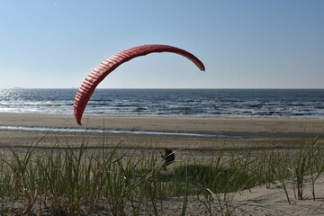 Paragliding at the beach of Katwijk aan Zee. Paraglider's making use of updraft of the dunes to stay in the air