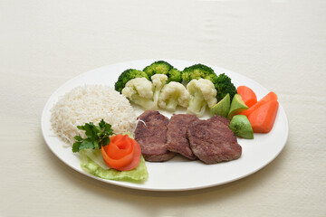 grilled fillet steak with white rice and vegetable salad