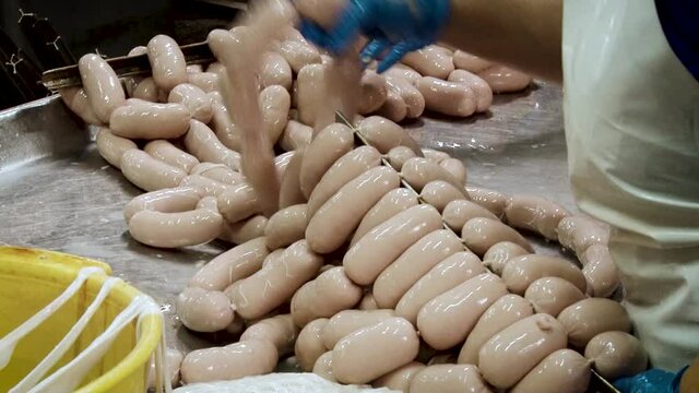 Stringing sausages. Meat factory in process.