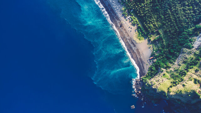 Aerial top view photo from flying drone of a paradise beach with tropical plants and blue calm sea with copy space for your advertising text message or promotional content. Beautiful nature wallpaper © BullRun