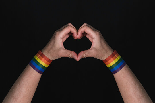 Heart. Hands making a heart. Supporting hands making a heart with the rainbow flag bracelet. Pride 2020. Gay pride. Love for gay pride. gay pride devices