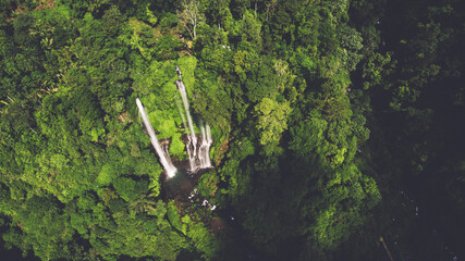 Top view aerial drone photo of magnificent waterfalls and tropical jungle all around.Group of beautiful wild waterfalls cut into the cliffs overgrown with tropical vegetation.Perfect nature background