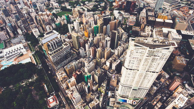 Top view aerial photo from drone of developed China city with tall skyscrapers and advanced transportation infrastructure. Office buildings in Hong Kong business district. Intelligent city background