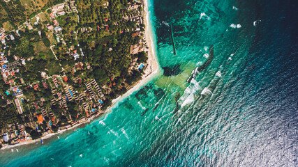 Top view aerial photo from flying drone of a beautiful Asian island with green plants and amazing blue color sea with waves. Beautiful nature landscape as background for your travel blog on website