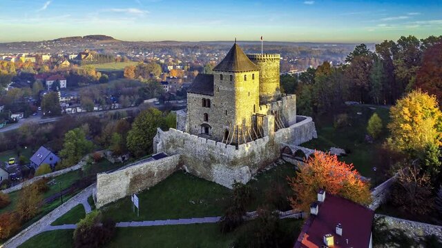 Medieval gothic castle in Bedzin, Upper Silesia, Poland. Aerial 4K approaching video in fall in sunrise light