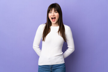 Young Ukrainian woman isolated on purple background with surprise facial expression