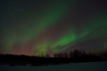 Fototapeta na wymiar beautiful aurora borealis over arctic circle landscape in winter