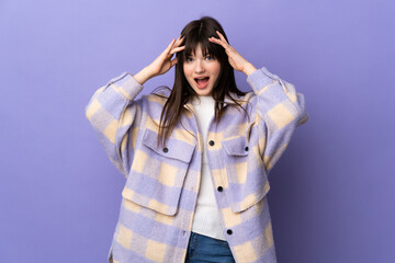 Young Ukrainian woman isolated on purple background with surprise expression