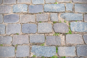 Fototapeta premium Stone pavement or road in old town as background, vintage cobblestone 