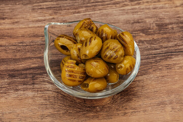 Green grilled olives in the bowl