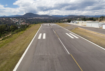 landing track of local airport with hangars at the side