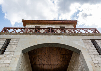 Bottom view of the castle arch against the blue cloudy sky, Bendery fortress, Moldova.