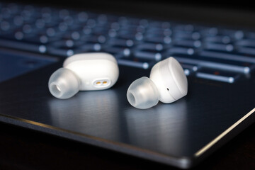 wireless bluetooth headphones on laptop background