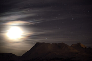 full moon over dark mountain silouette