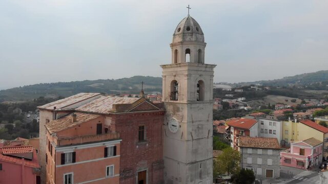 Aerial drone shot over the historic center of Sirolo with church and bell tower at summer day.  - 4K aerial drone video clip