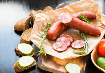 Sandwich. Rye Baguette with Sausage and cucumbers.