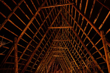 old wooden stockfish structure at night