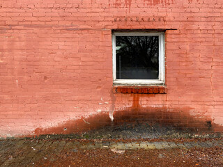water leaking from window damaged alley brick building