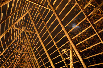 old wooden stockfish structure at night