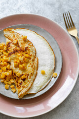 Freshly made omelet on a gray background