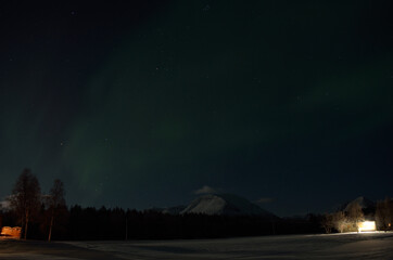 Naklejka na ściany i meble aurora borealis, northern light in the arctic circle at night time