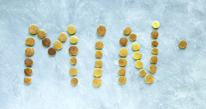 Stop motion animation of Trendy food - pancake cereal. mini cereal pancakes in text MINI. Top view or flat lay.