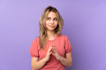Teenager Russian girl isolated on purple background scheming something