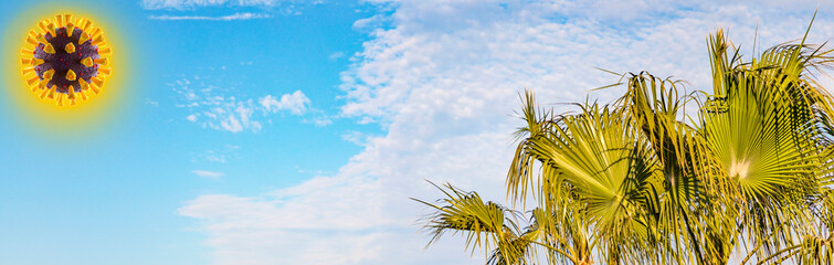 Covid-19-Virus als Sonne, weltweite Reise-Warnungen. Palmen im Vordergrund, im Hintergrund ein blauer Himmel mit Wolken, Panorama.