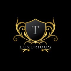 Obraz premium Golden Letter T Luxurious Shield Logo, vector design concept for luxuries business identity