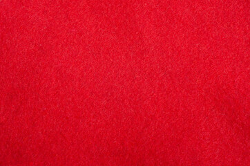 The texture of the red fabric on the Santa hat. New Year and Christmas background.