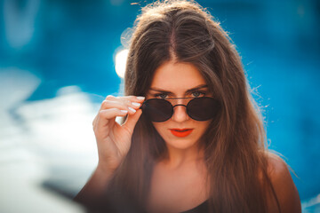 sexy young model at the sea by the pool