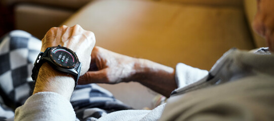 old man checking his condition on his smart watch