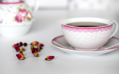a cup of tea with dried roses
