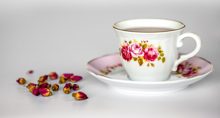 a cup of tea with dried roses
