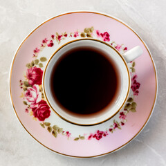 Top view of a cup of tea with dried roses