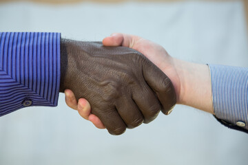 Black lives matter. Close up photo of a handshake between afroamerican and european hands.