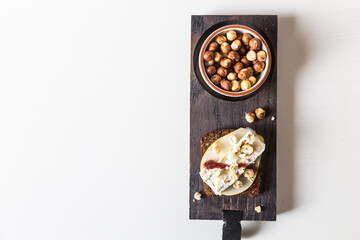 Open sandwich with rye bread, fresh pear , gorgonzola  cheese, hazelnuts and cranberry sauce and...