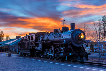 The train to the Grand Canyon waiting at Williams Station, Arizona at sunset - Powered by Adobe