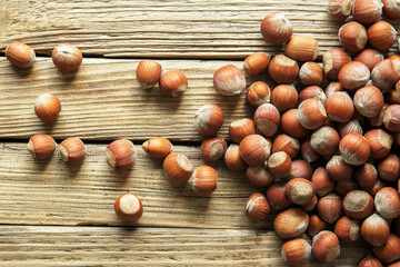 Raw hazelnut on a wooden background. Top view.