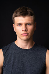 Fototapeta premium Portrait of young man over isolated black background