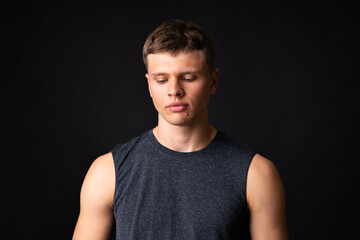 Portrait of young man over isolated black background