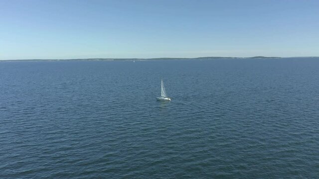 Sailboat in the ocean, aerial view.